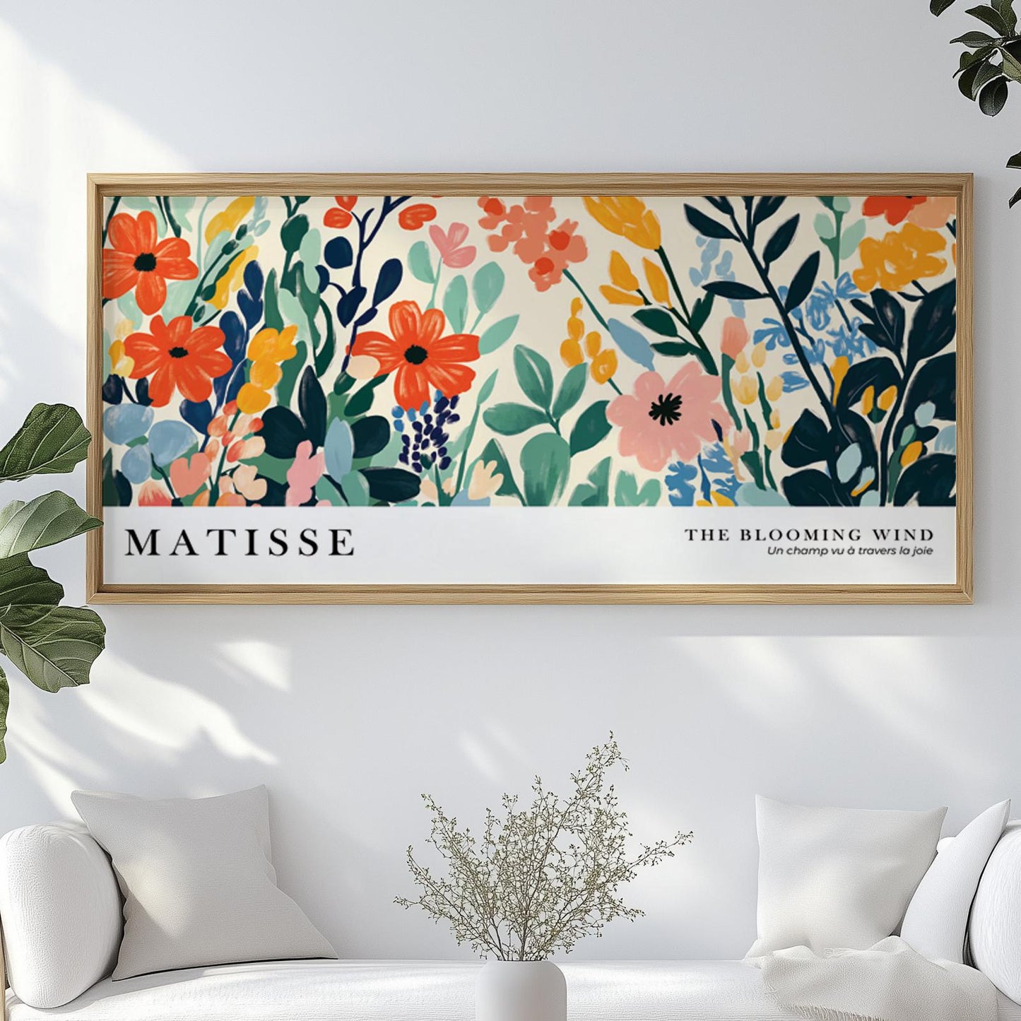 Matisse-inspired colorful wild flower print in a light wood frame above a white sofa.