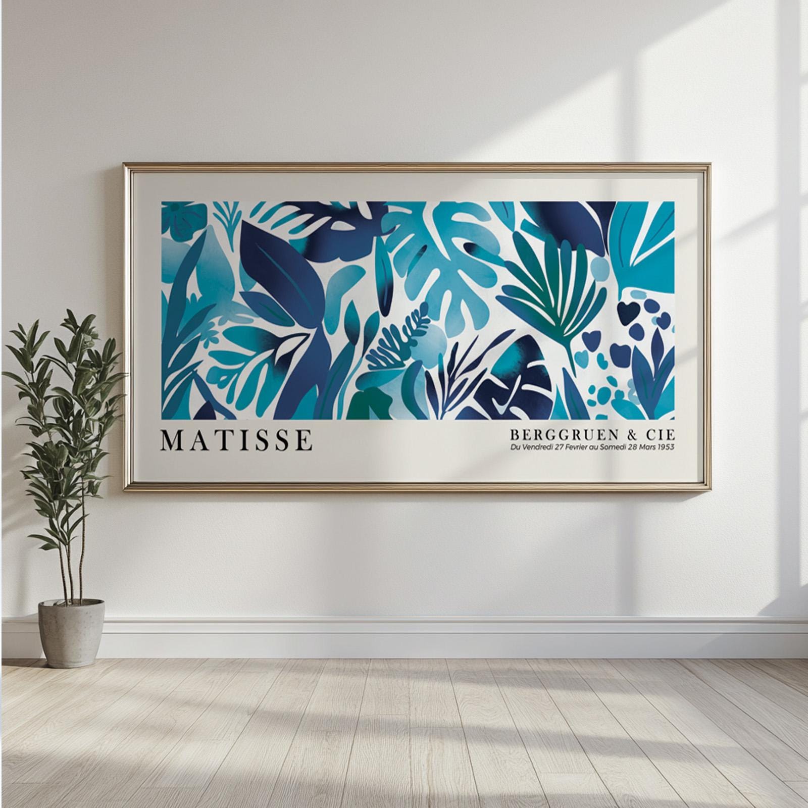 Framed blue Matisse-style tropical leaves artwork displayed above a modern console cabinet