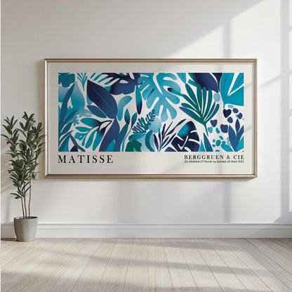 Framed blue Matisse-style tropical leaves artwork displayed above a modern console cabinet