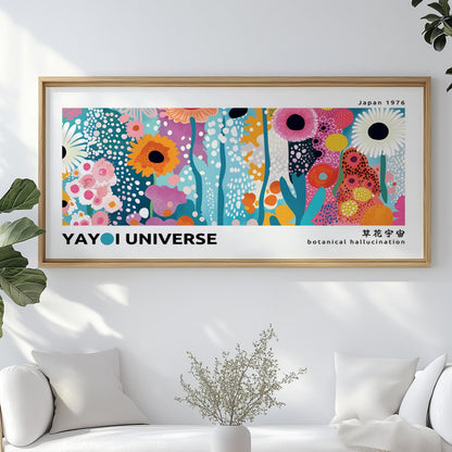 Panoramic abstract floral print in a light wood frame centered above a white sofa.