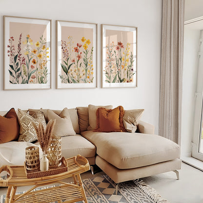 Meadow flower wall art triptych with delicate yellow, terracotta and blush wildflowers on neutral backgrounds.
