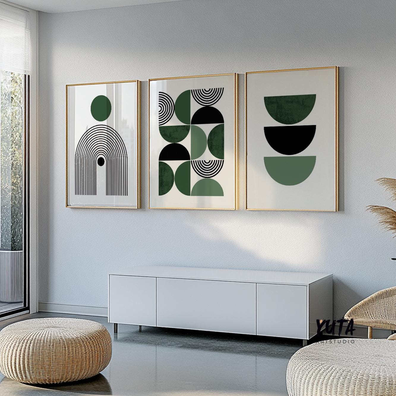 Three framed Bauhaus abstract prints hung in a row above a white cabinet in soft daylight