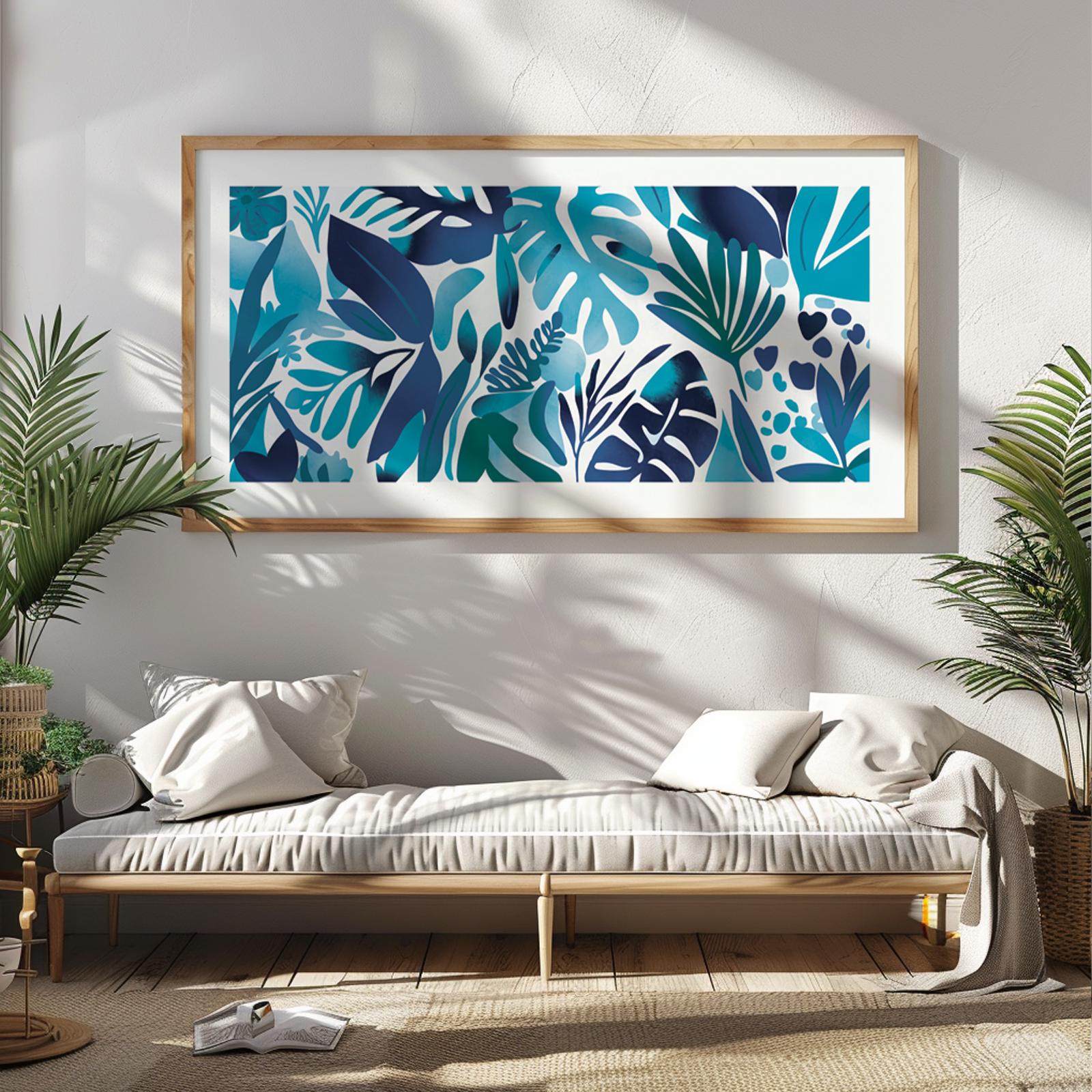Framed blue tropical leaves artwork in panoramic format above a light wood console