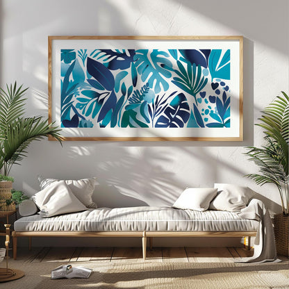 Framed blue tropical leaves artwork in panoramic format above a light wood console