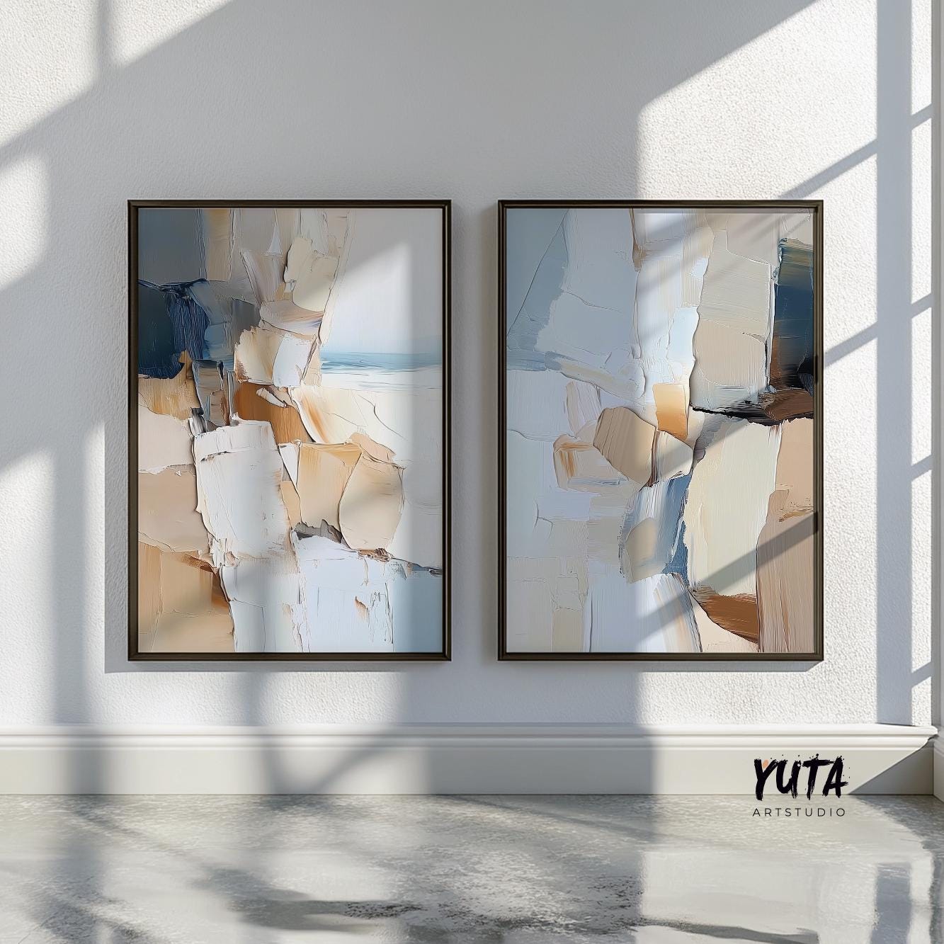 Two abstract coastal prints in brown wood frames styled near sunlit indoor plants