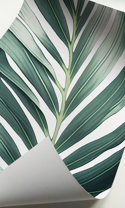Green botanical wall art with oversized tropical foliage