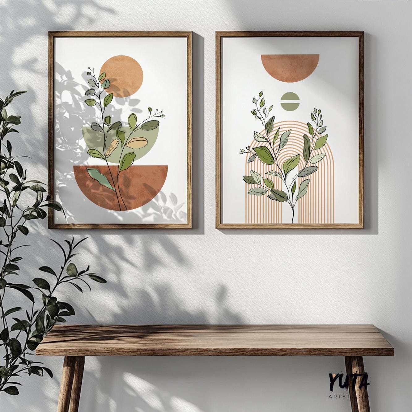Abstract terracotta botanical prints in wooden frames styled above a slim console table