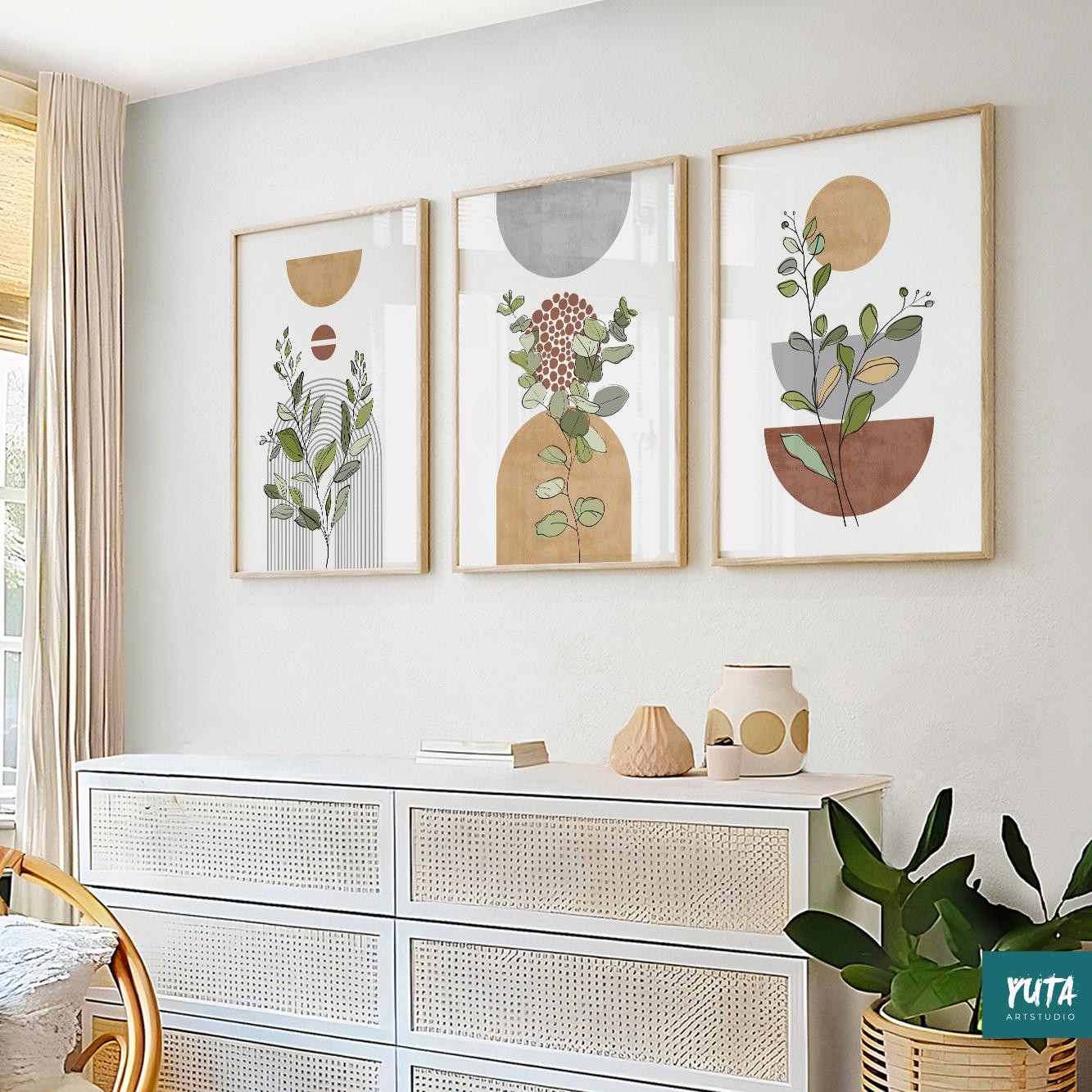 Set of three framed abstract botanical prints in terracotta and grey above a white dresser