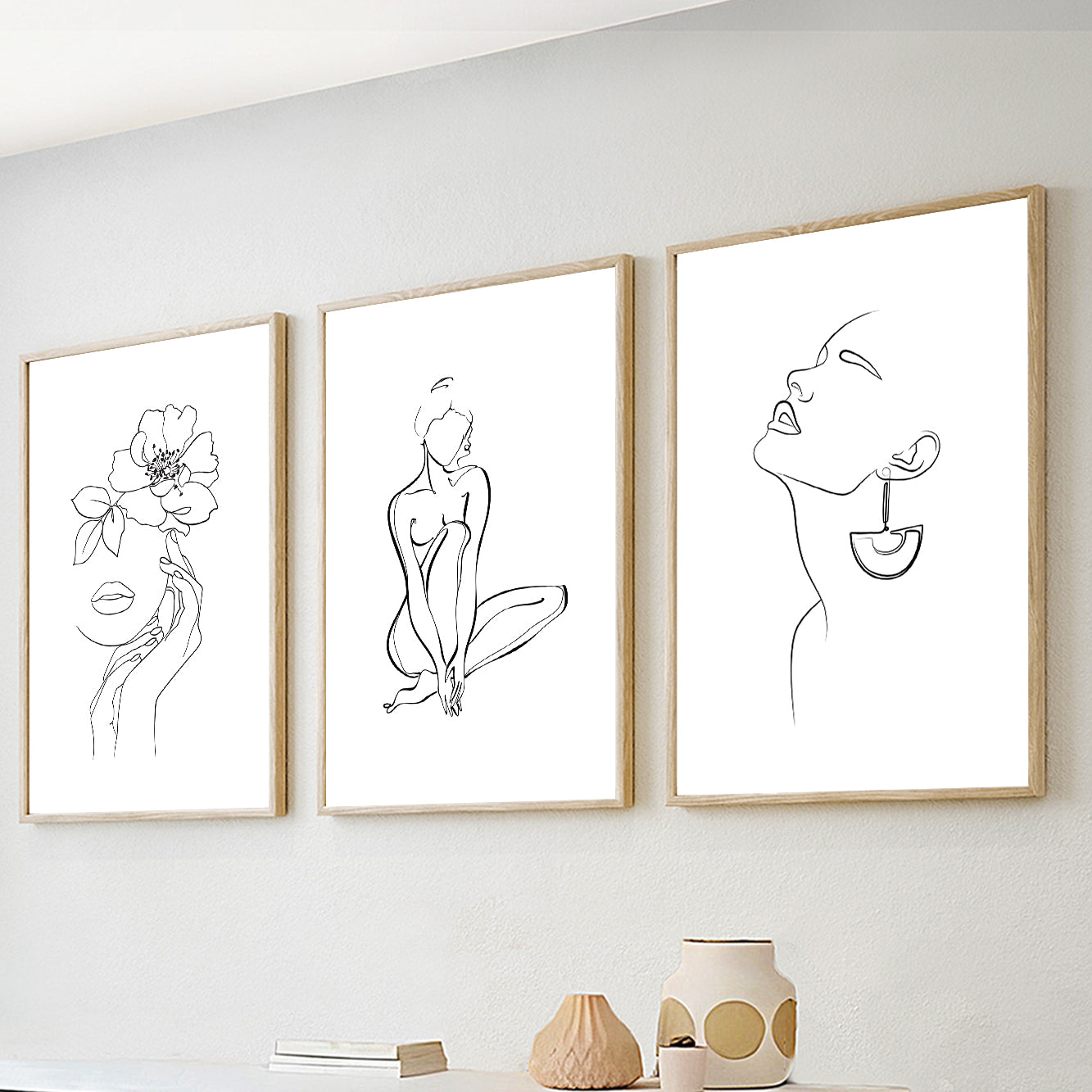 Minimalist line art wall art set of 3 featuring abstract female portraits and botanical line drawings in black and white