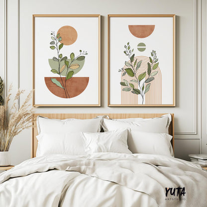 Two large framed boho botanical prints with terracotta and beige geometric shapes over a bed