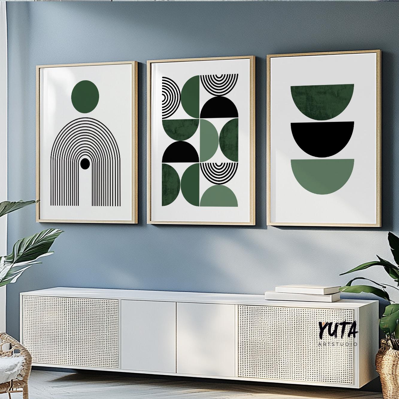 Three framed Bauhaus geometric prints in green and black above a modern white console