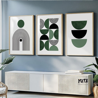 Three framed Bauhaus geometric prints in green and black above a modern white console