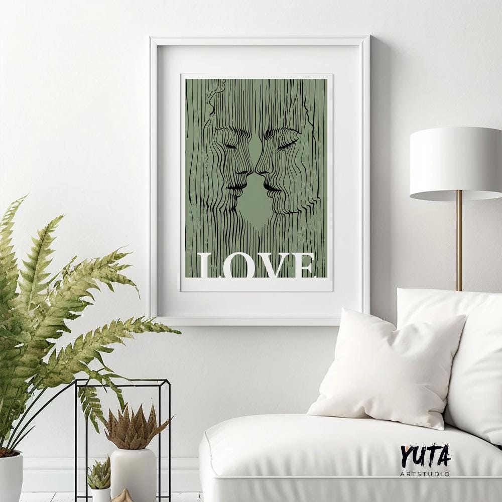 Framed abstract couple print with sage green lines above a modern white lounge chair