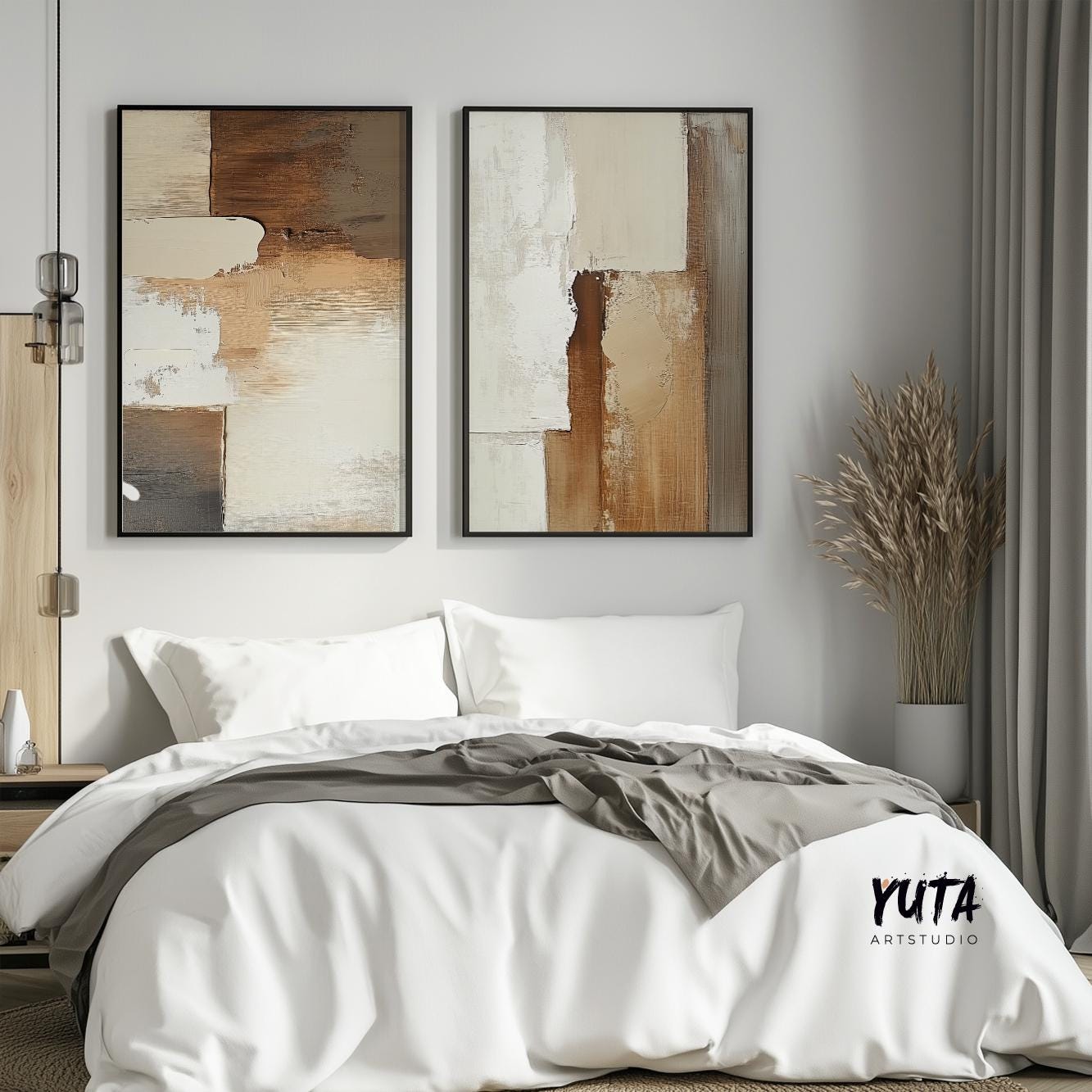 Two neutral abstract prints in black frames displayed above a bed for scale reference