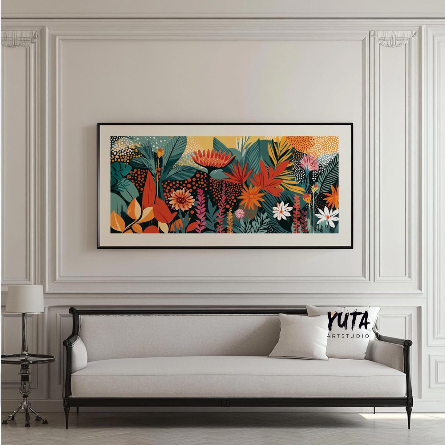 Framed panoramic tropical floral artwork with bold abstract shapes above a white sofa.