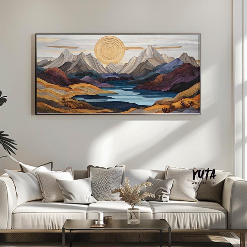 Framed pastel mountain landscape artwork hung above a neutral sideboard with minimal decor