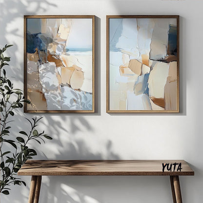 Abstract coastal wall art pair in wood frames above a minimalist wood console