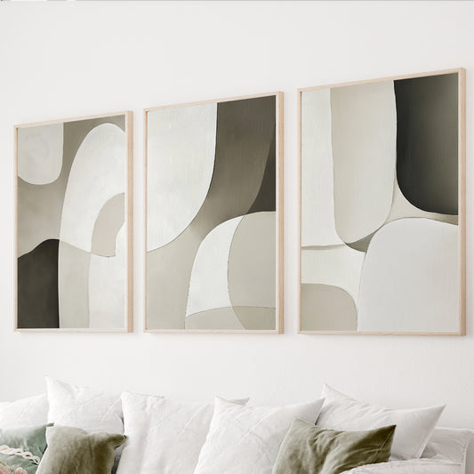 Neutral abstract wall art set of 3 featuring large organic shapes in cream, taupe, beige and dark brown.