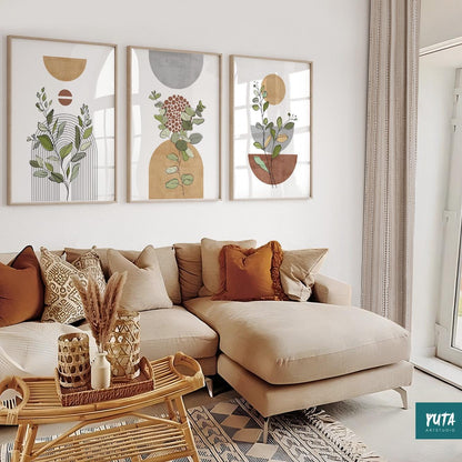 Framed boho abstract botanical prints in a trio above a sectional sofa in a bright room