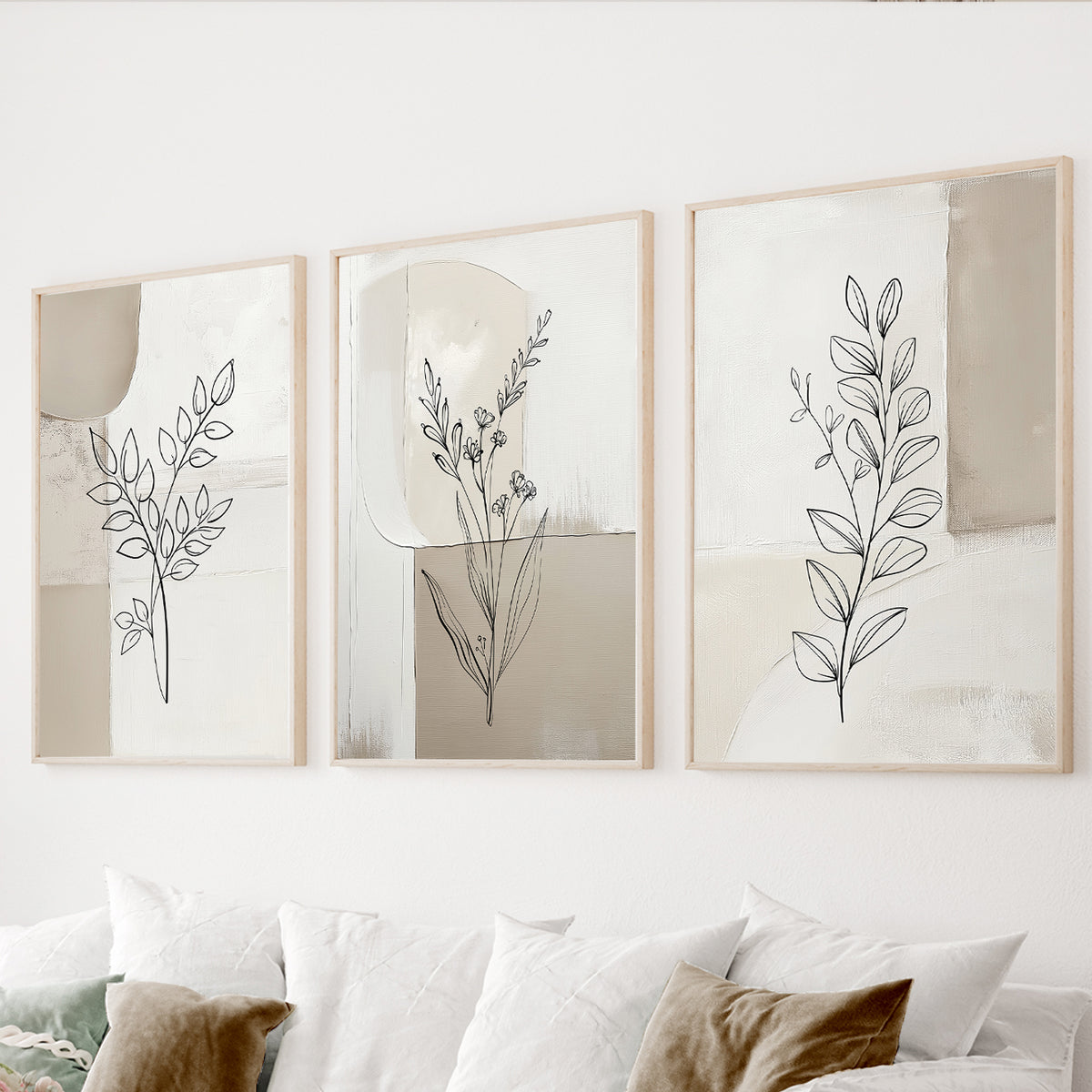 Neutral botanical wall art set of 3 featuring black leaf line drawings over textured beige, cream and ivory abstract backgrounds.