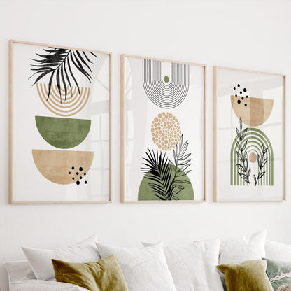 Abstract botanical prints in earthy tones arranged as a framed trio above a pale sofa