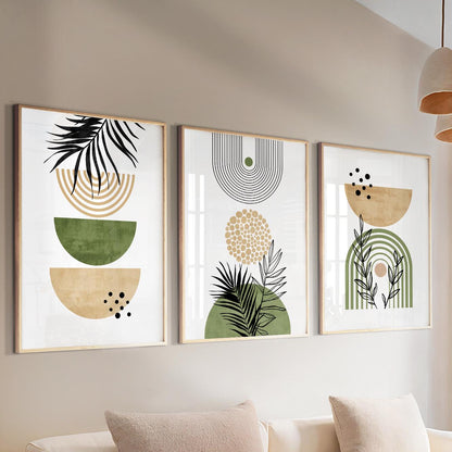 Three framed abstract botanical prints in earthy tones hung above a light sofa in daylight