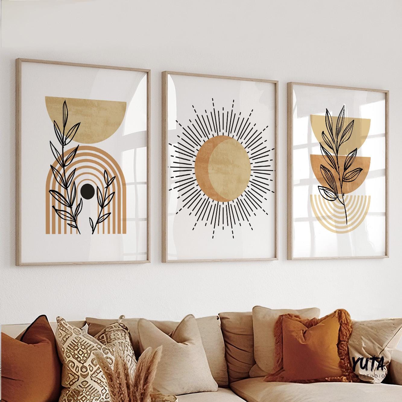 Framed abstract terracotta boho prints arranged above a sideboard with decorative vases