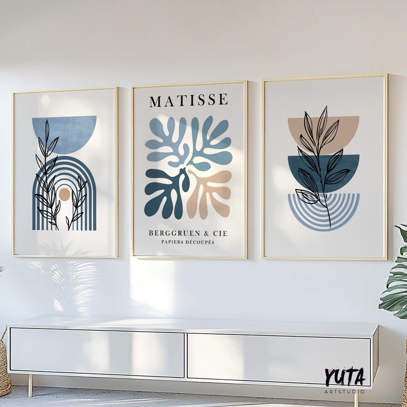 Three framed mid-century modern prints shown above a cabinet with proportional wall art sizing.