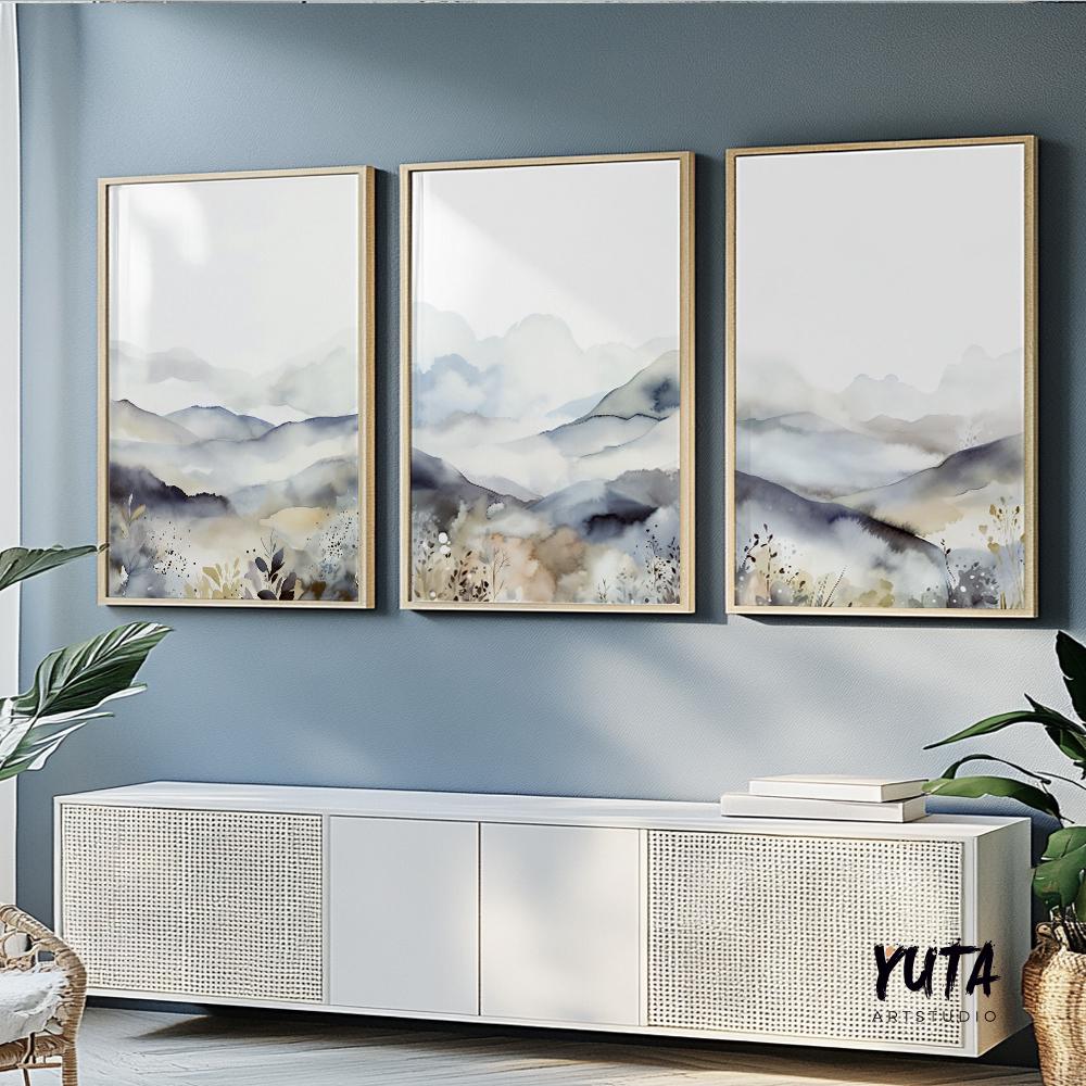 Neutral watercolor mountain triptych framed above a modern white sideboard