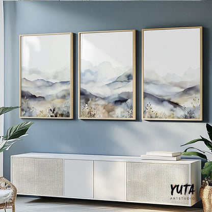 Neutral watercolor mountain triptych framed above a modern white sideboard