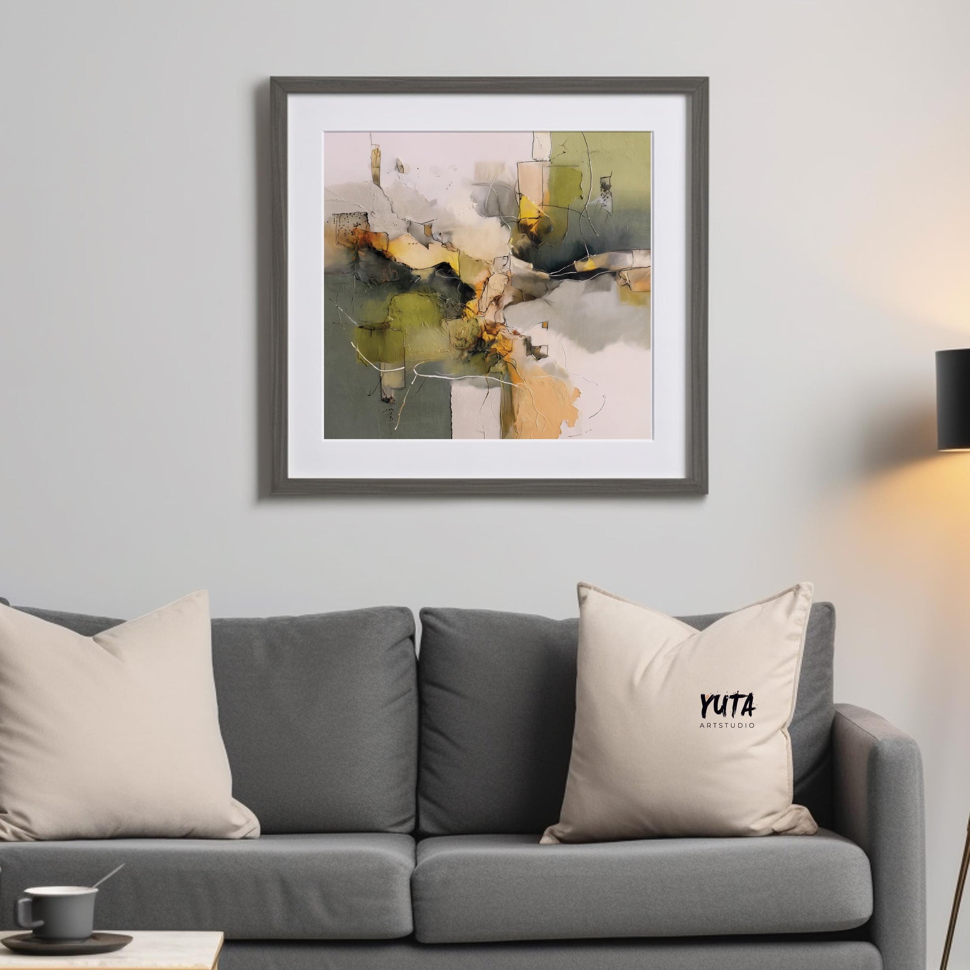 Abstract olive green and beige framed print shown in medium size above a sofa for scale