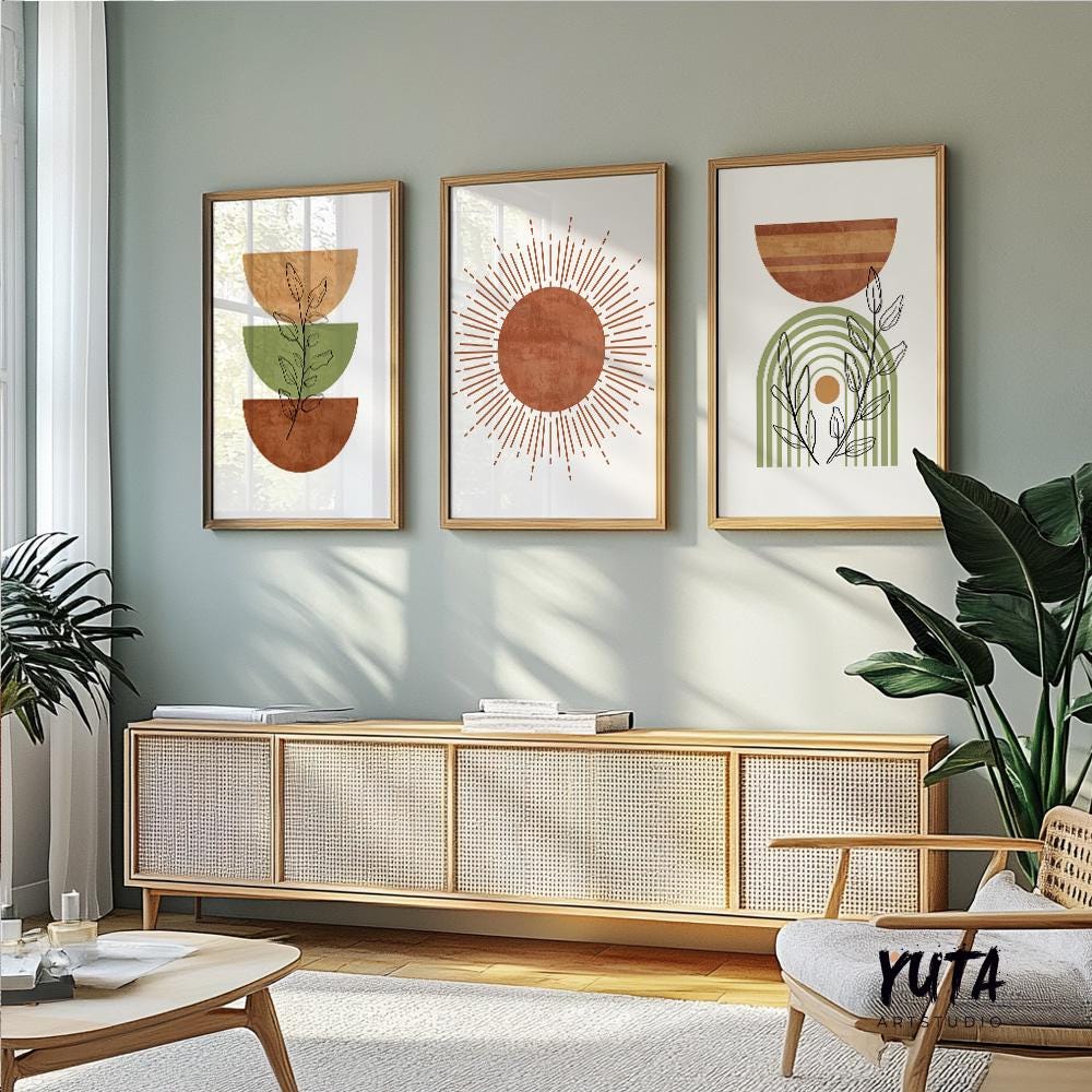 Three framed abstract boho prints arranged above a light wood sofa in a sunlit room
