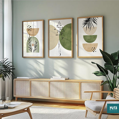 Set of three framed green and beige abstract prints arranged above a rattan sideboard in natural daylight