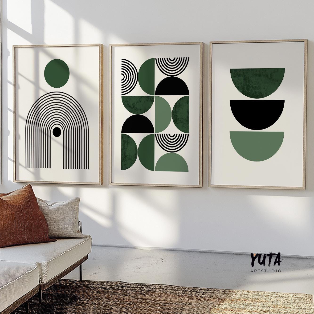 Three framed Bauhaus-inspired abstract prints arranged above a modern cream sofa