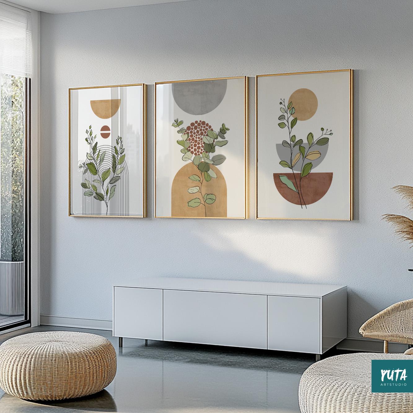 Botanical terracotta and grey abstract prints in gold frames above a woven pouf seating.