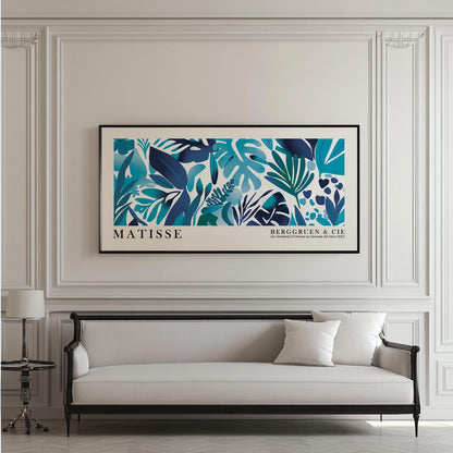 Framed blue Matisse-inspired tropical leaves print hung above a classic sofa on paneled wall