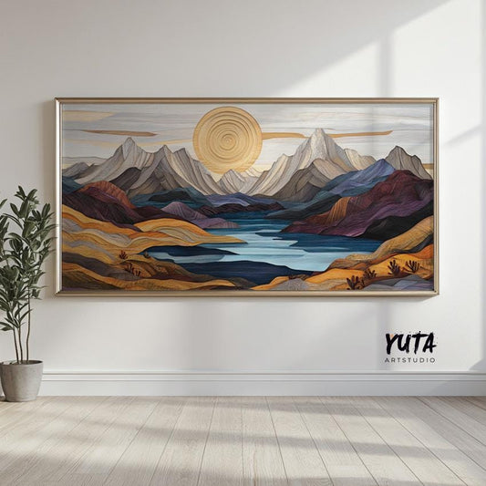 Pastel mountain landscape artwork in a silver frame, displayed on a bright wall