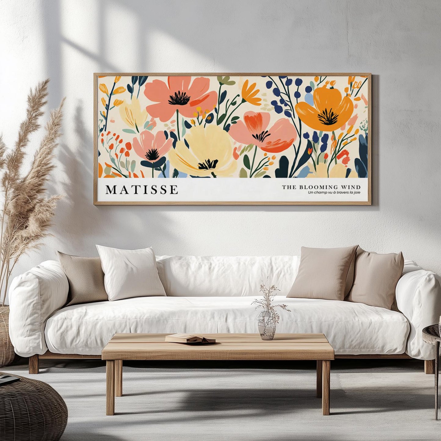 Colorful Matisse-inspired floral art in a natural wood frame displayed above a white sofa