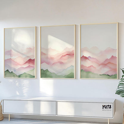 Sage and blush abstract mountain triptych in thin frames above a modern white console