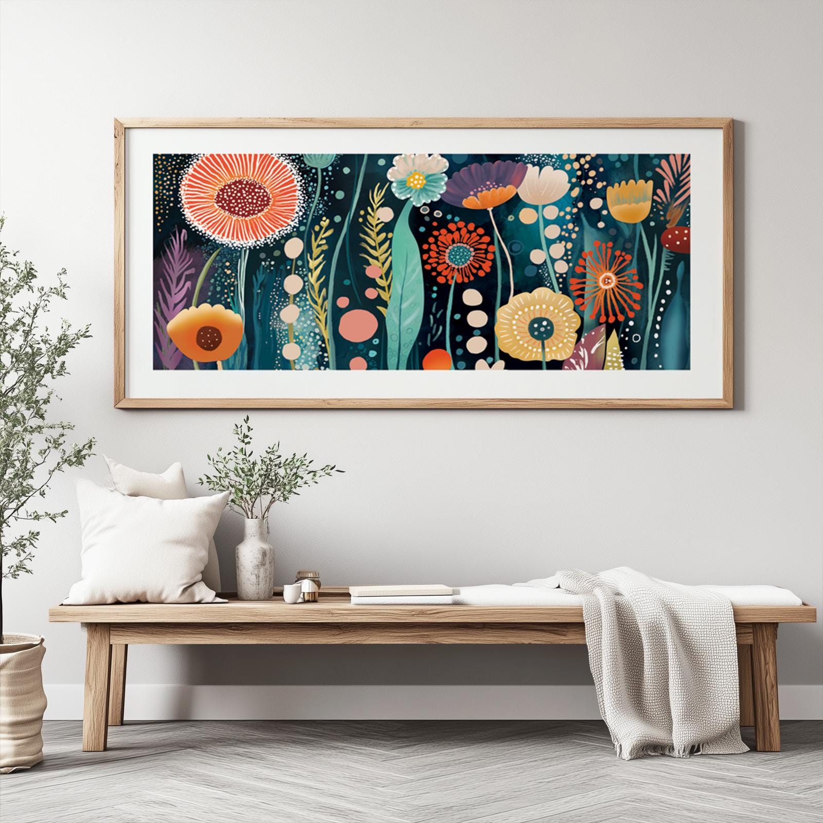 Panoramic abstract floral wall art in a natural wood frame shown above a low bench for scale