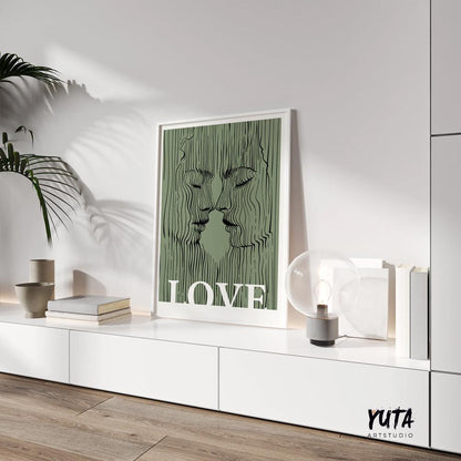 Minimalist sage green couple print with abstract line faces in a white frame on a shelf