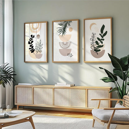 Pastel abstract botanical prints in natural wood frames arranged as a trio above a console