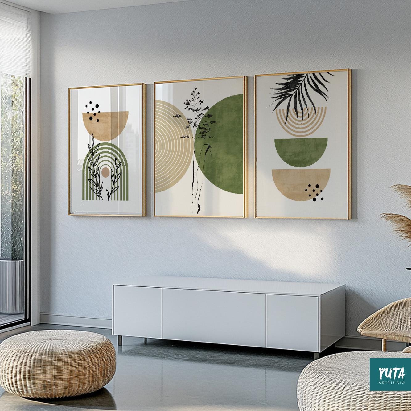 Abstract boho art trio with geometric shapes and botanical lines in gold frames above a white cabinet