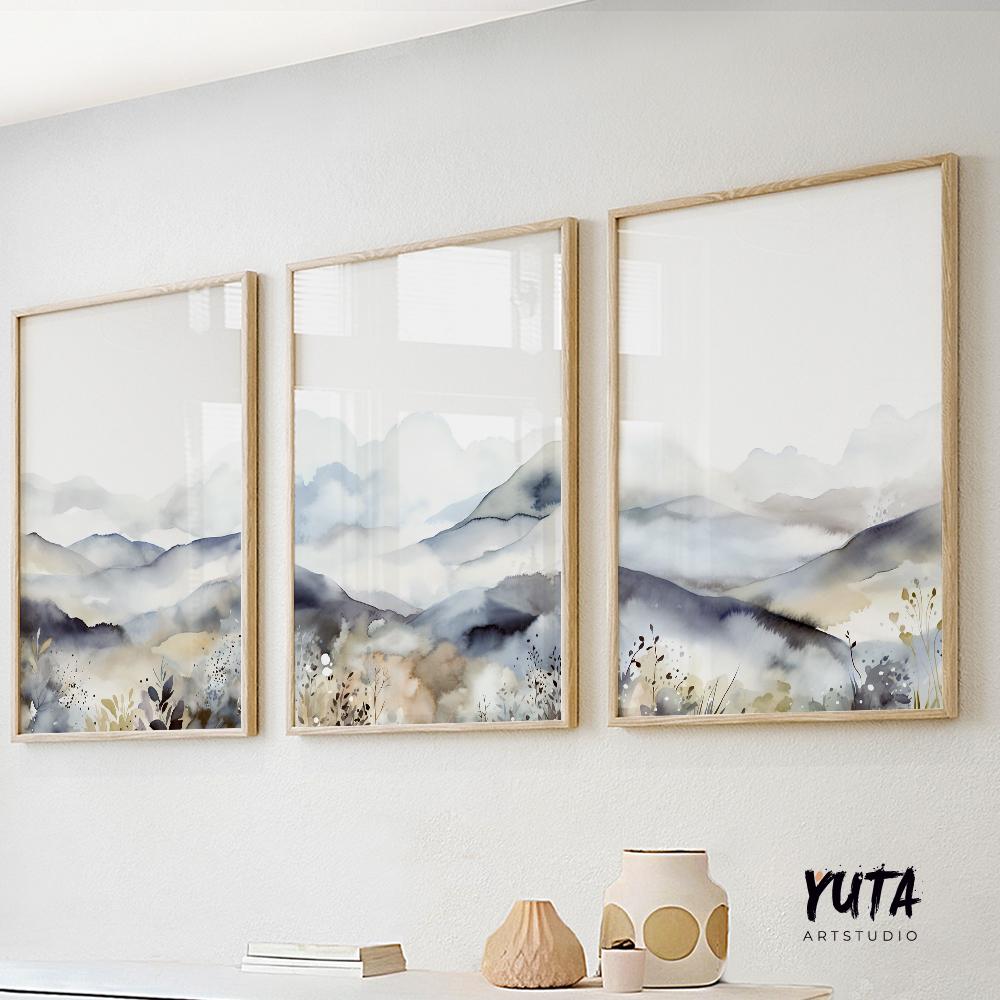 Watercolor mountain triptych in light wood frames, displayed above a console in daylight