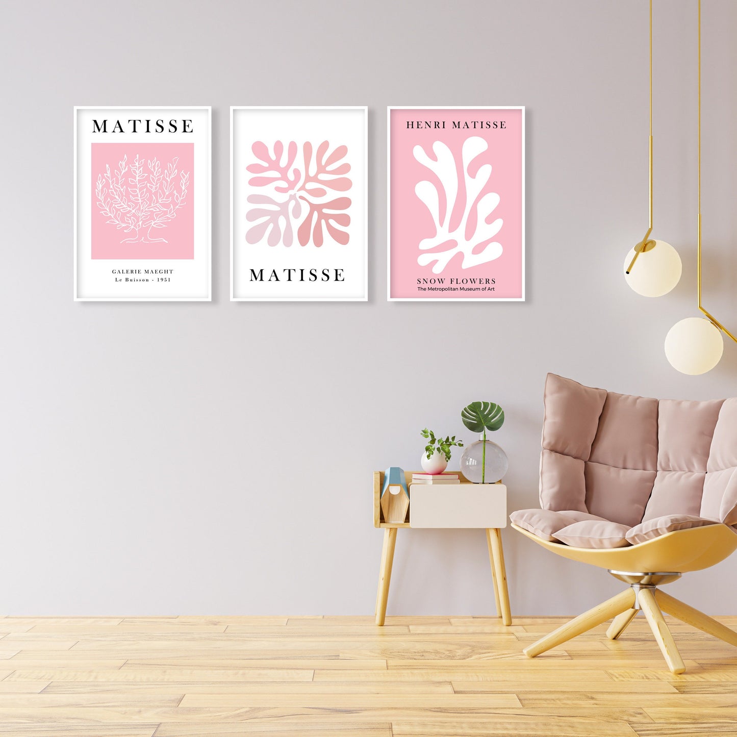 Three pastel pink Matisse prints in white frames arranged above a modern chair and table