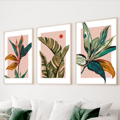 Tropical botanical wall art set of 3 featuring colorful palm leaves on blush pink backgrounds