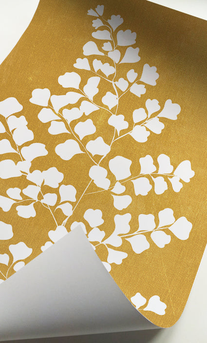Warm yellow botanical wall art with tropical leaf silhouettes for modern interiors