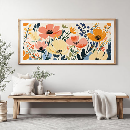 Panoramic abstract wildflower artwork in a light wood frame, displayed in natural daylight