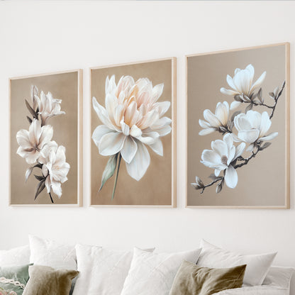 White floral wall art set of 3 featuring elegant magnolia and botanical flowers on warm beige backgrounds.
