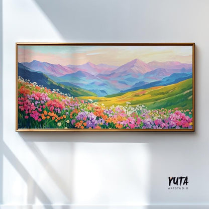 Vibrant wildflower and mountain landscape painting in a light wood frame on a sunlit wall
